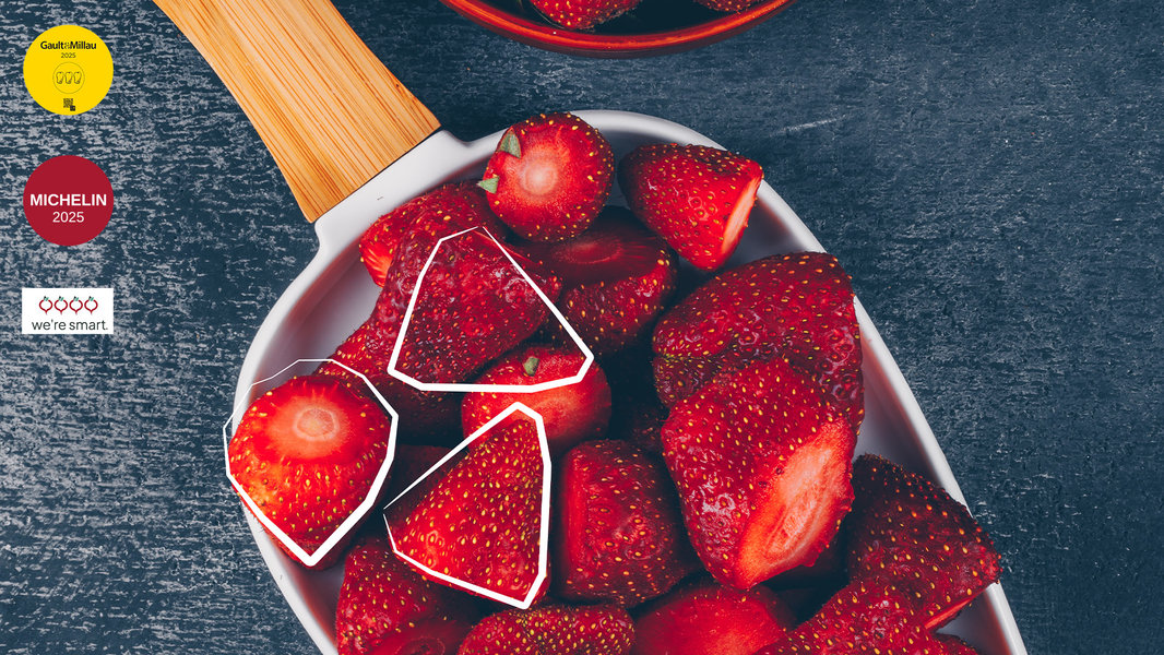 Das Titelbild der Sommerbroschüre zeigt eine Schaufel voll frischer Erdbeeren.